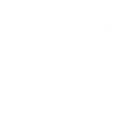 Ein Bagger führt den Abriss eines Gebäudes durch, während Trümmer auf dem Boden liegen.